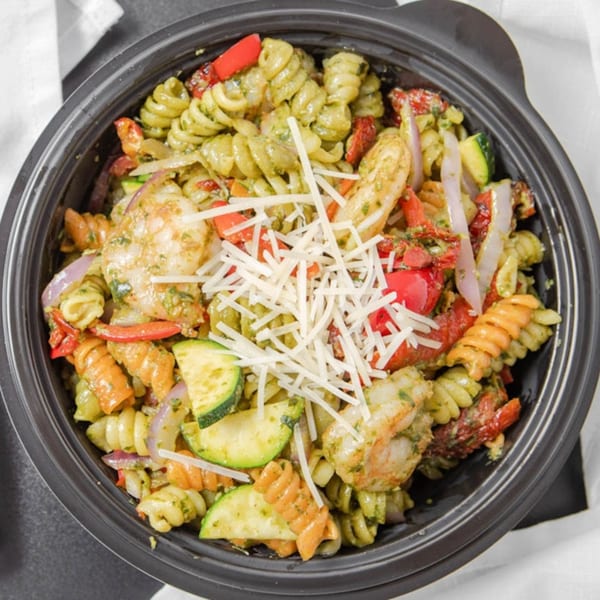 Fresh Millions' pesto pasta with shrimp, zucchini, red peppers, red onion, and shredded cheese.